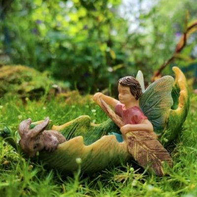 boy fairy figurine with boat