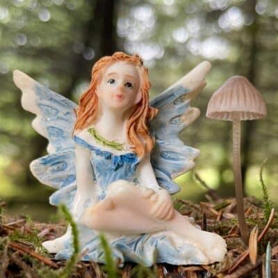 fairy figurine in a woodland setting